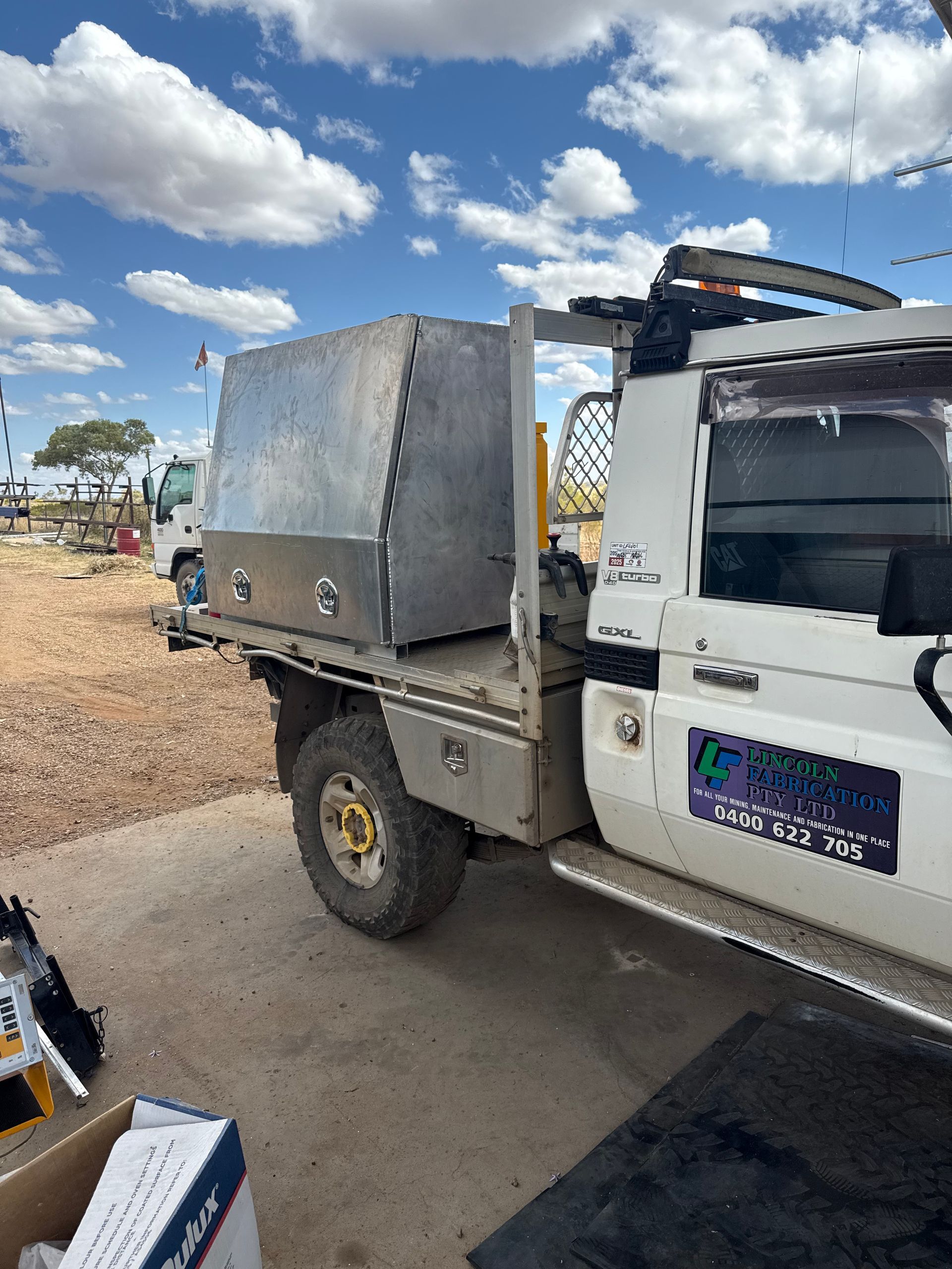 A White Utility Truck With a Large Metal Storage Box — Lincoln Fabrication in Miles End, QLD