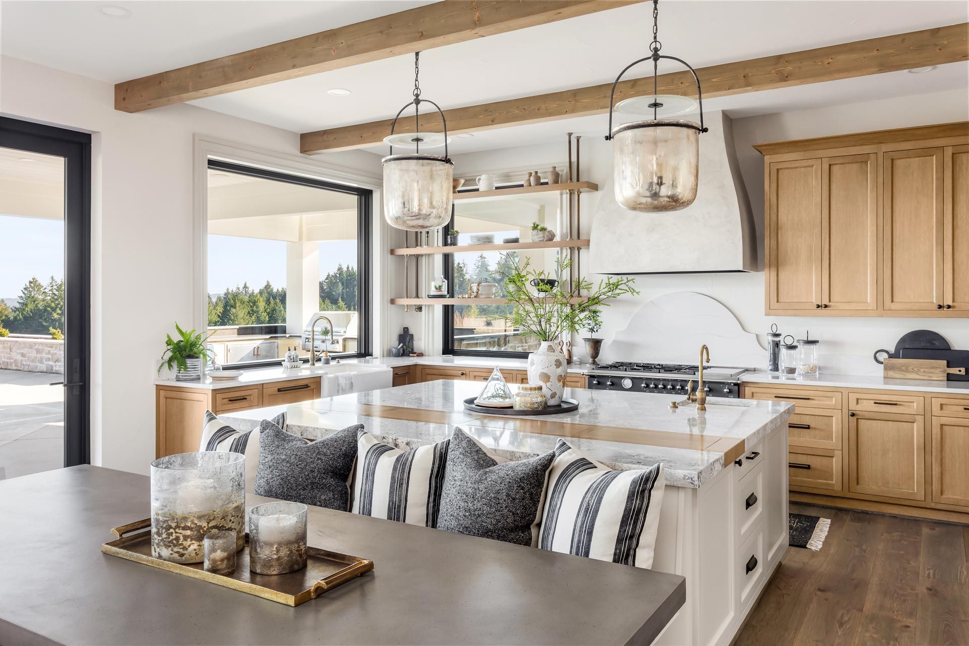 Bright modern kitchen and dining area with wood cabinets, island seating, and pendant lights
