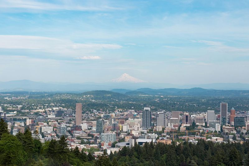 An aerial view of a city with mountains in the background. An aerial view of a city with mountains in the background.