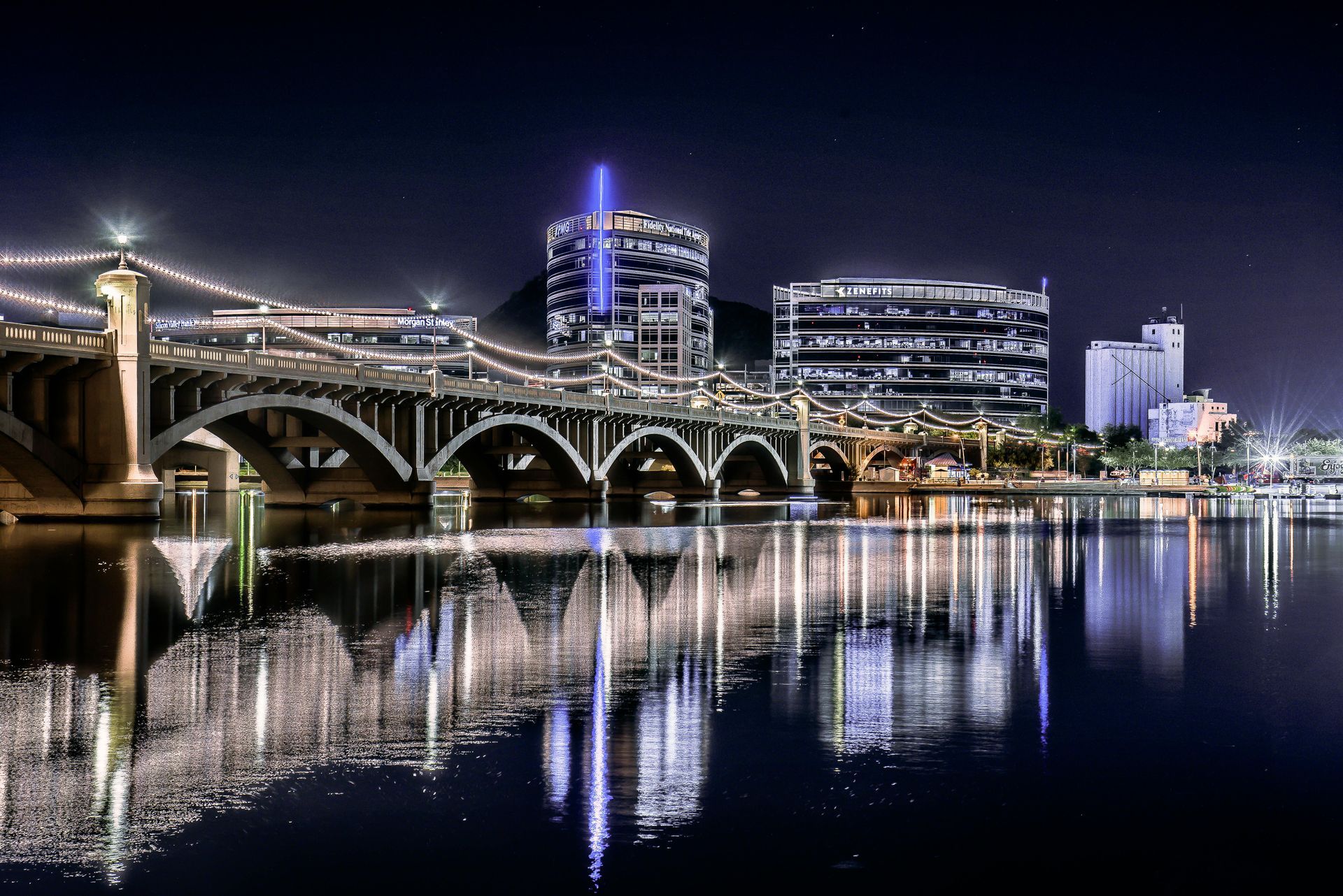 The skyline of New Jersey is reflected in a lake.