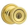 A brass door knob with a key in it on a white background.