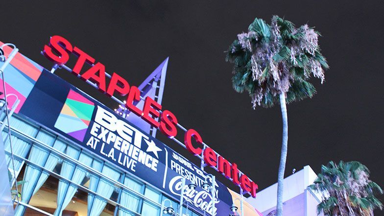 Staples Center sign at night, featuring red letters and a palm tree.