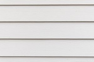 Close-up of overlapping light gray horizontal siding panels with a subtle wood grain texture.