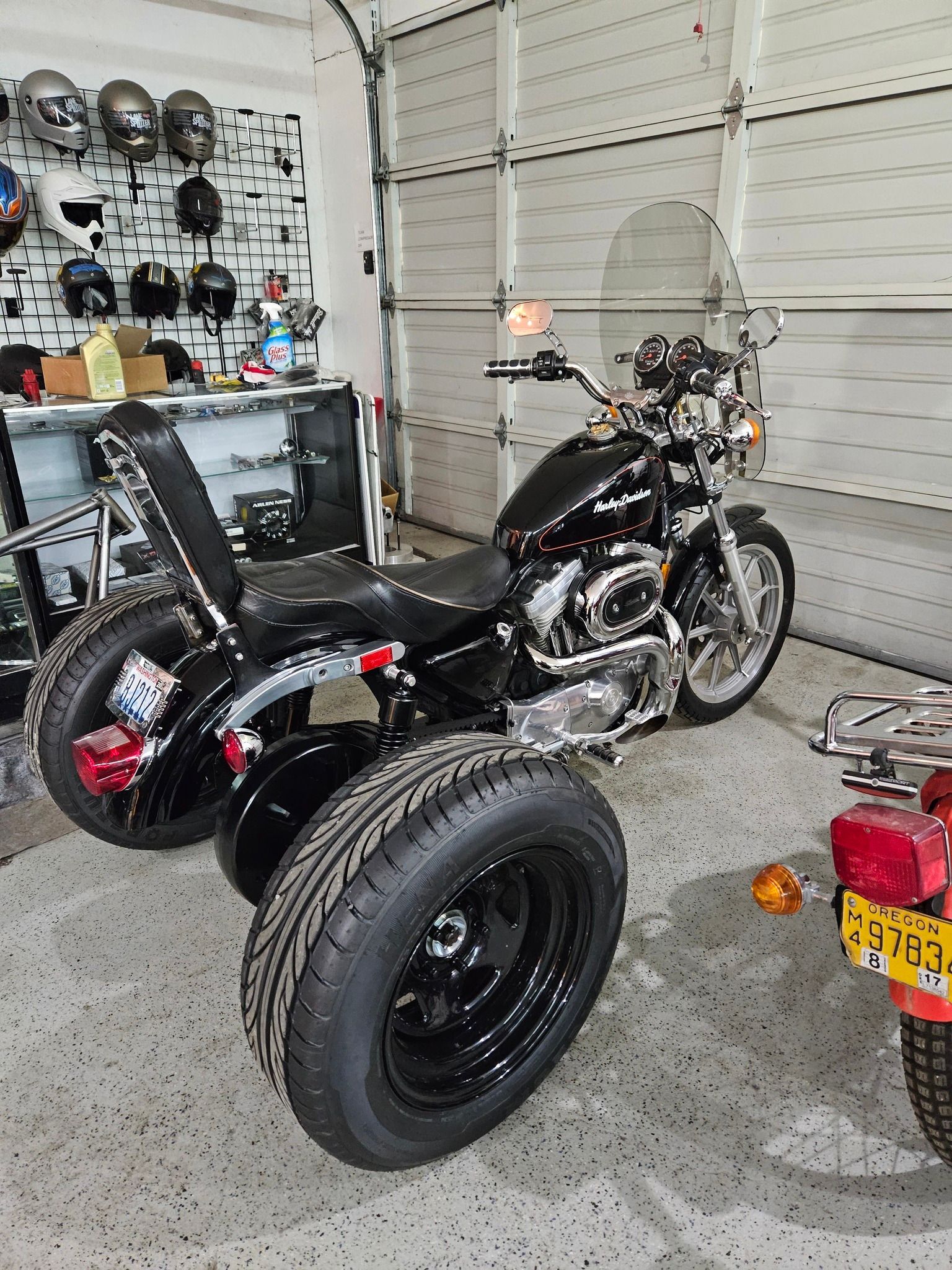 A motorcycle with three wheels is parked in a garage.