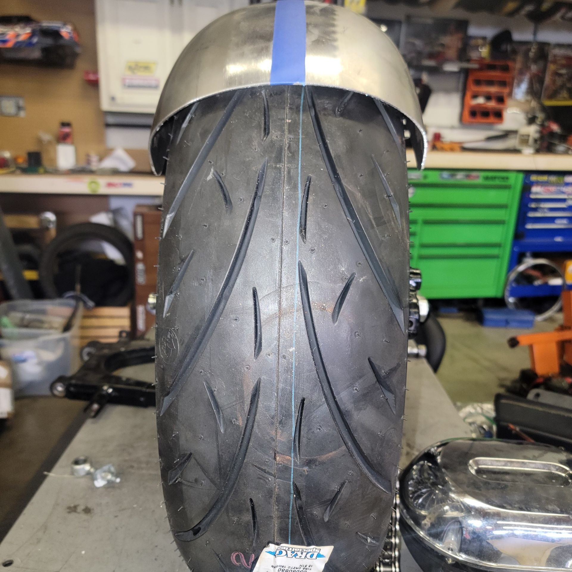 A close up of a motorcycle tire with a blue stripe on it