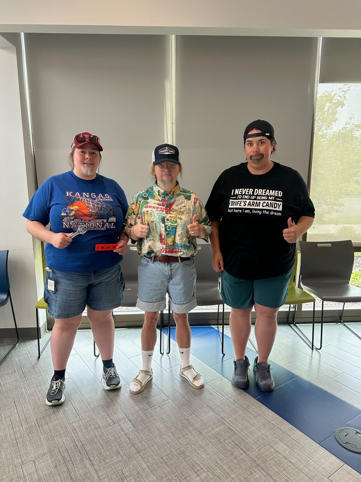 Three female staff dressed as their fathers, facial hair and all, standing in our waiting room.