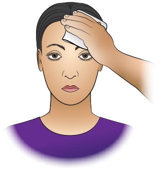 A hand applies a cool compress to a person's forehead.
