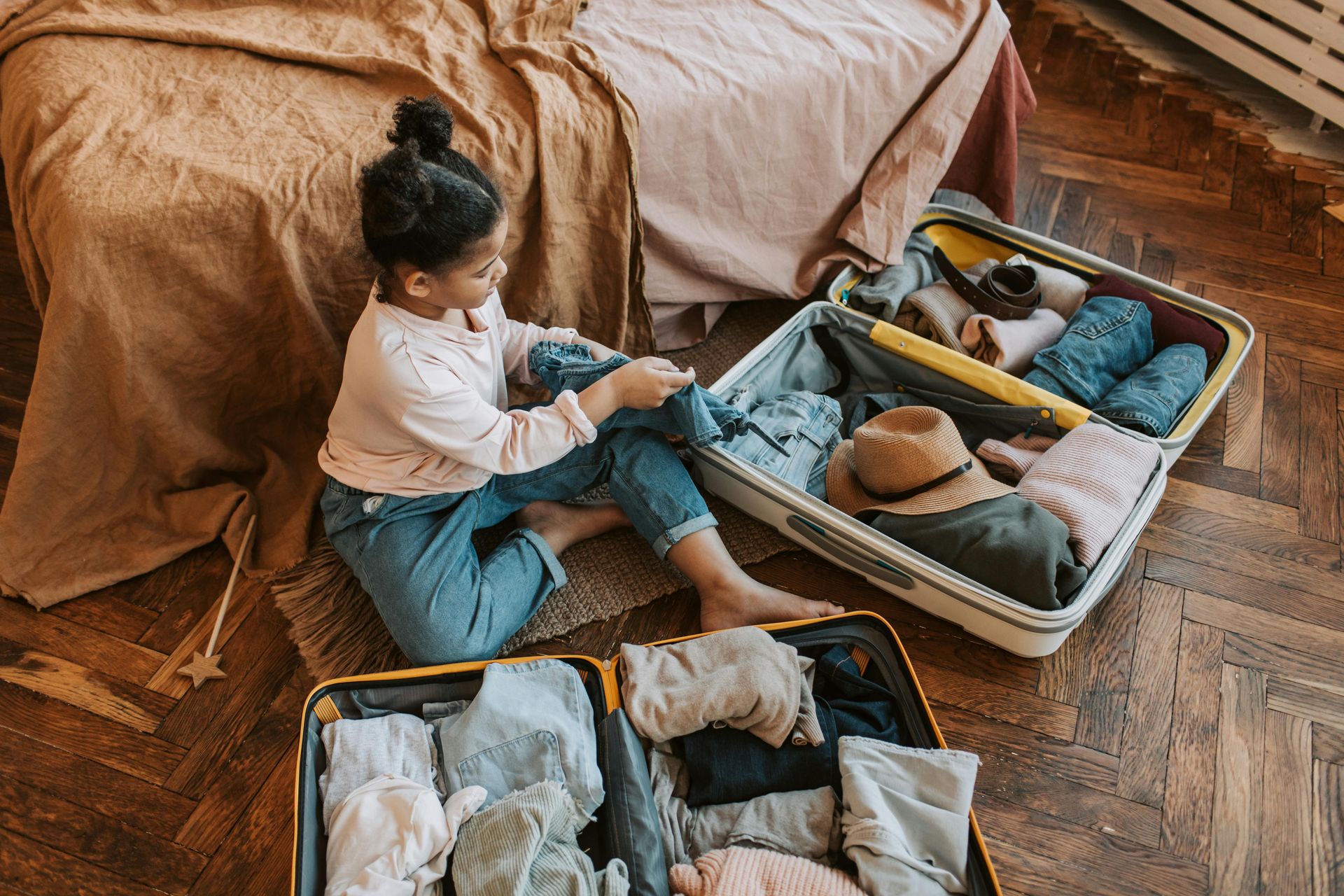 Girl packing suitcases for vacation