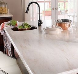 A kitchen with a sink , refrigerator , and dishwasher.