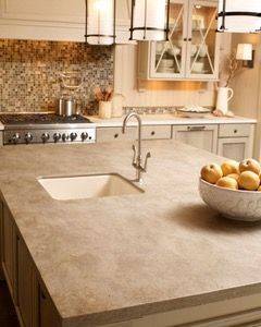 A kitchen with a sink , stove , and dishwasher.