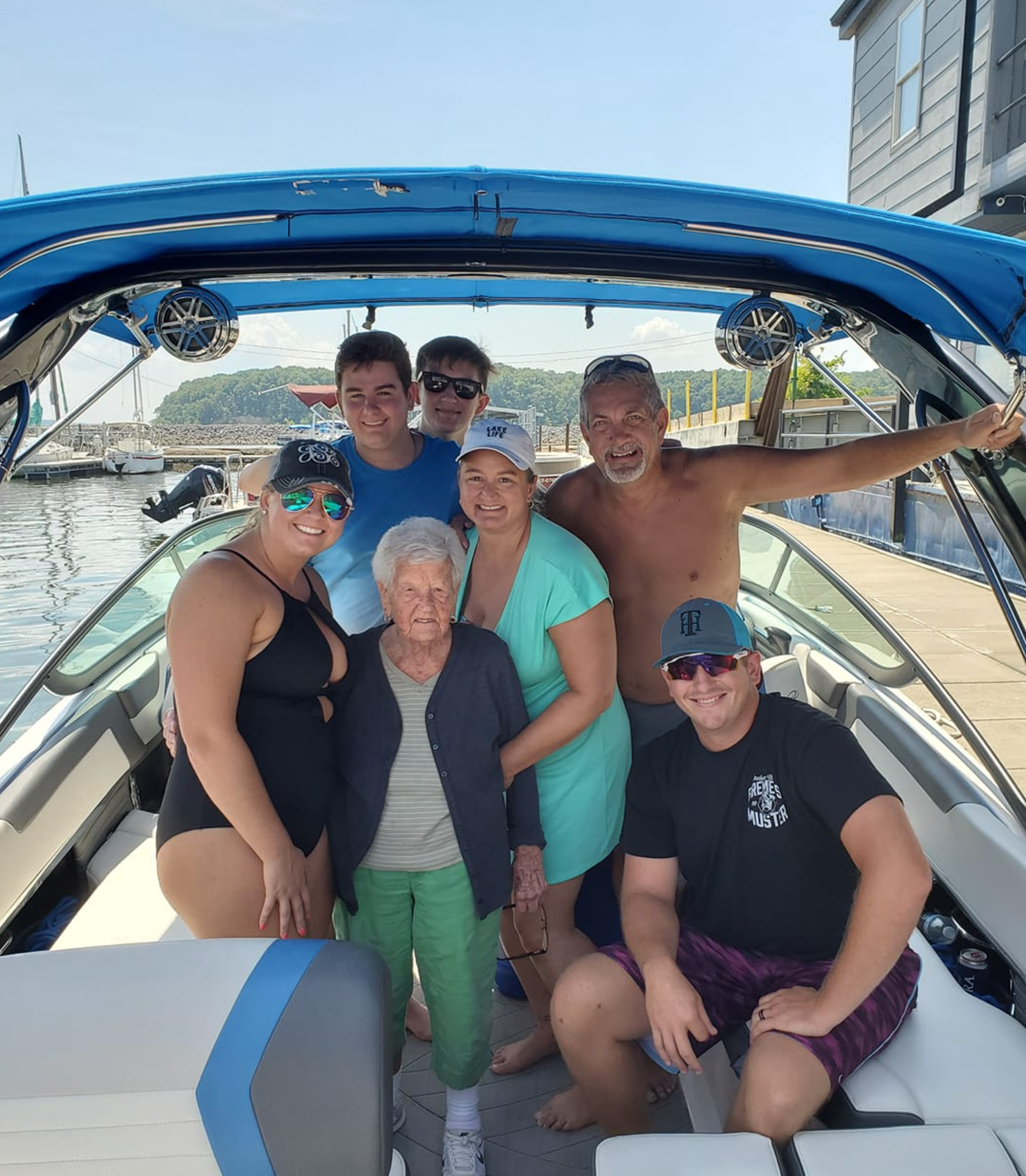 A group of people are posing for a picture on a boat.