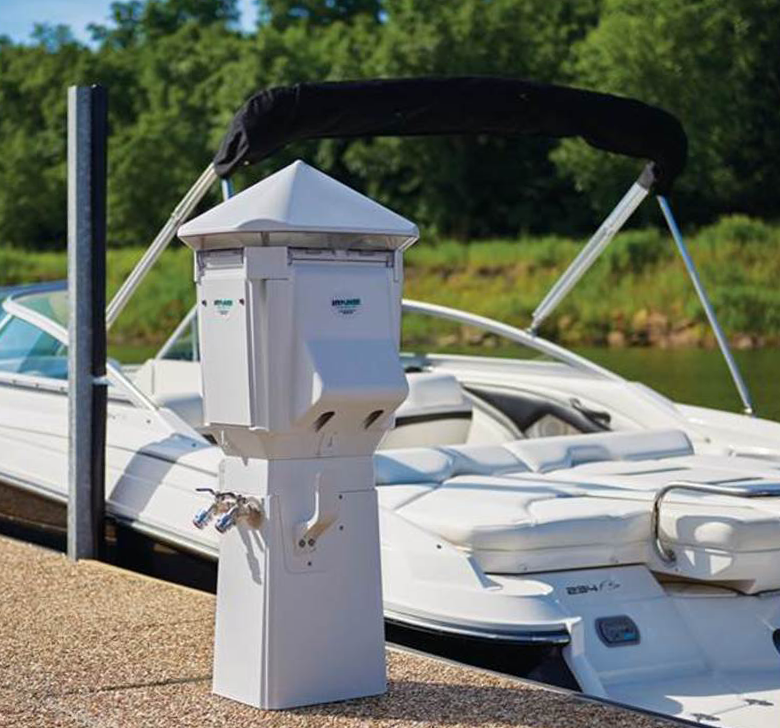 A white boat is docked next to a white post