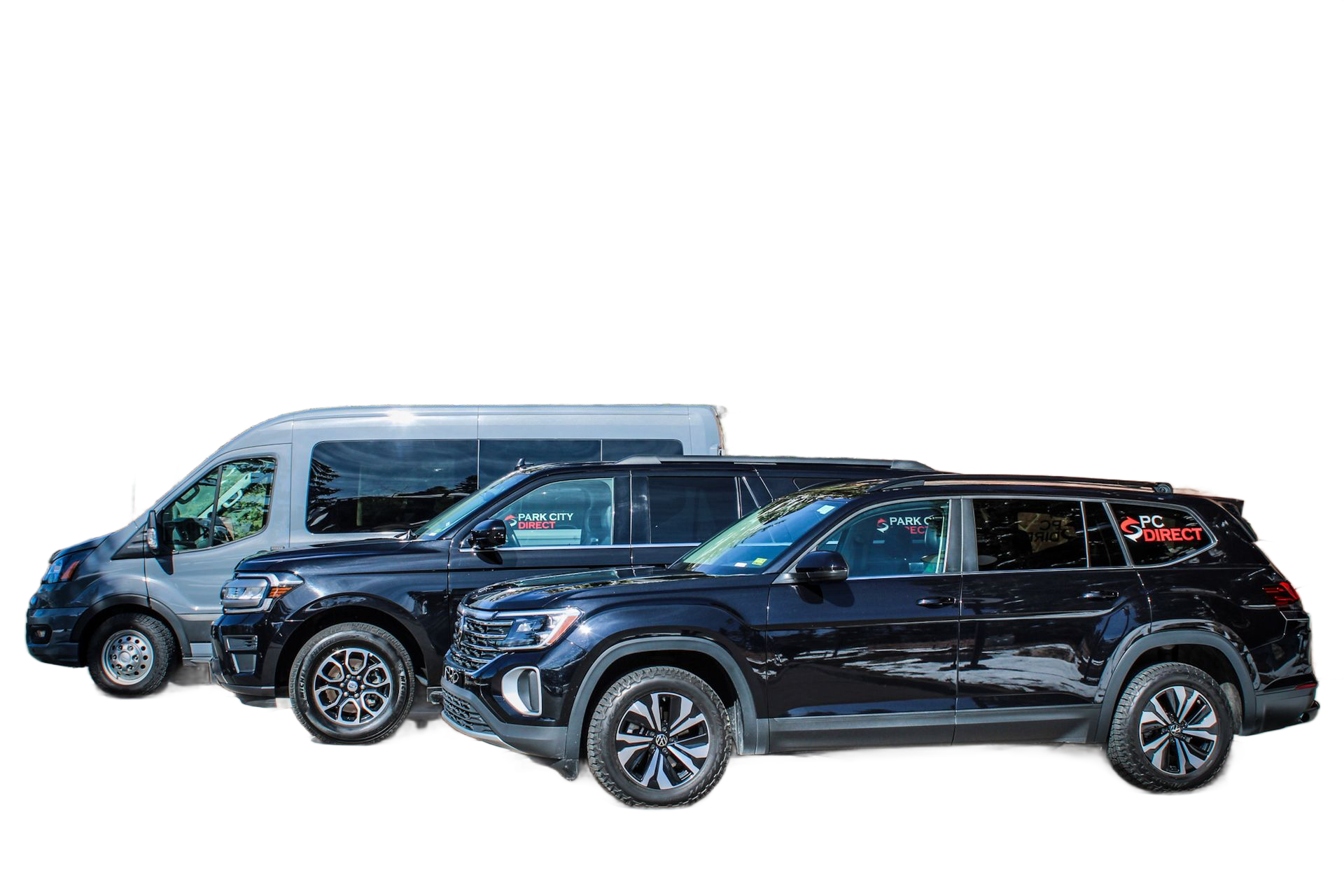 Three cars are parked in front of a brick building.