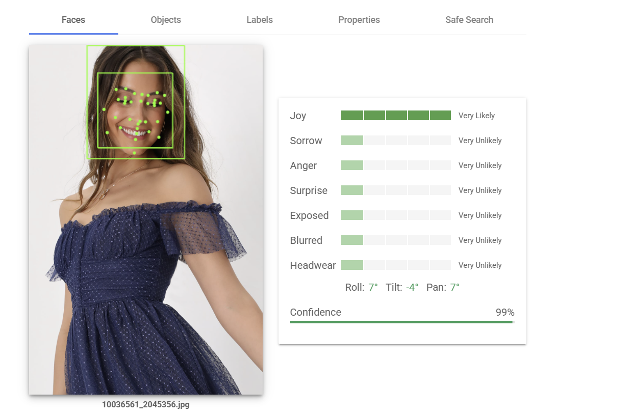Joyful woman wearing a fun little spring dress that’s blue with little dots. This image is analyzed by Google Cloud Vision to identify the emotions on her face. 
