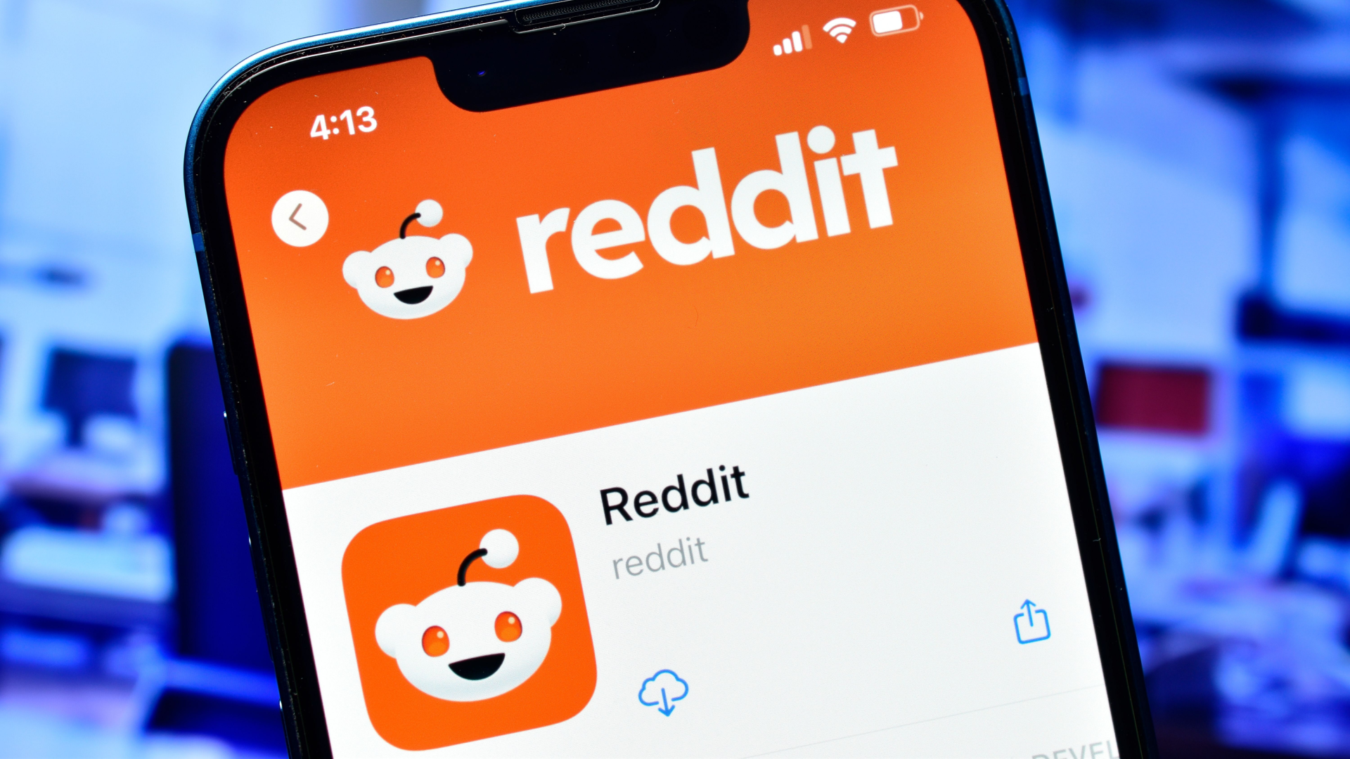 Reddit app icon displayed on a phone screen, featuring the Reddit logo on an orange background.