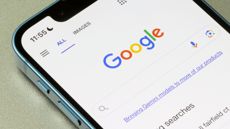 Close-up of a smartphone screen displaying the Google search engine's homepage.