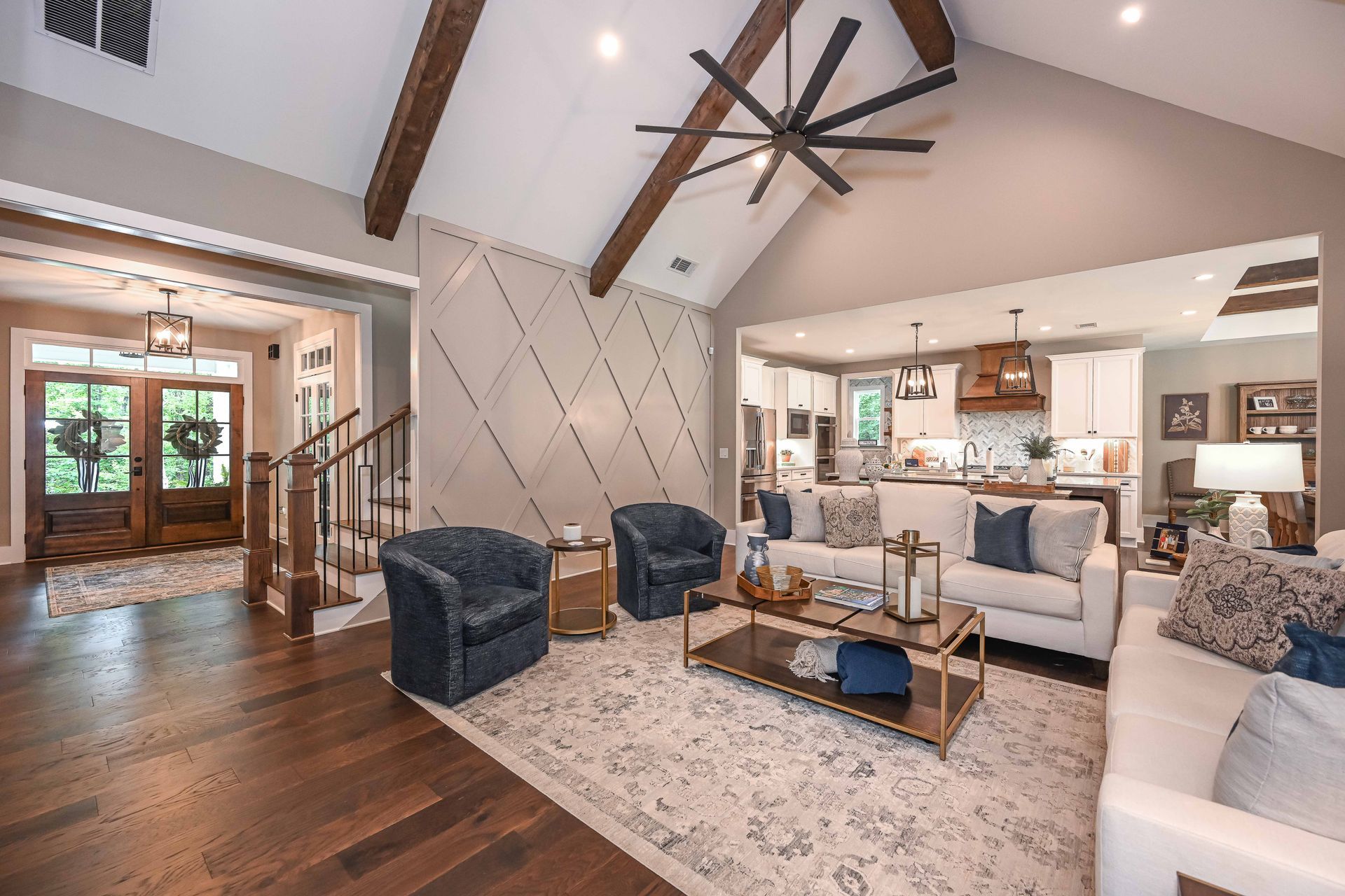 A living room filled with furniture and a ceiling fan.
