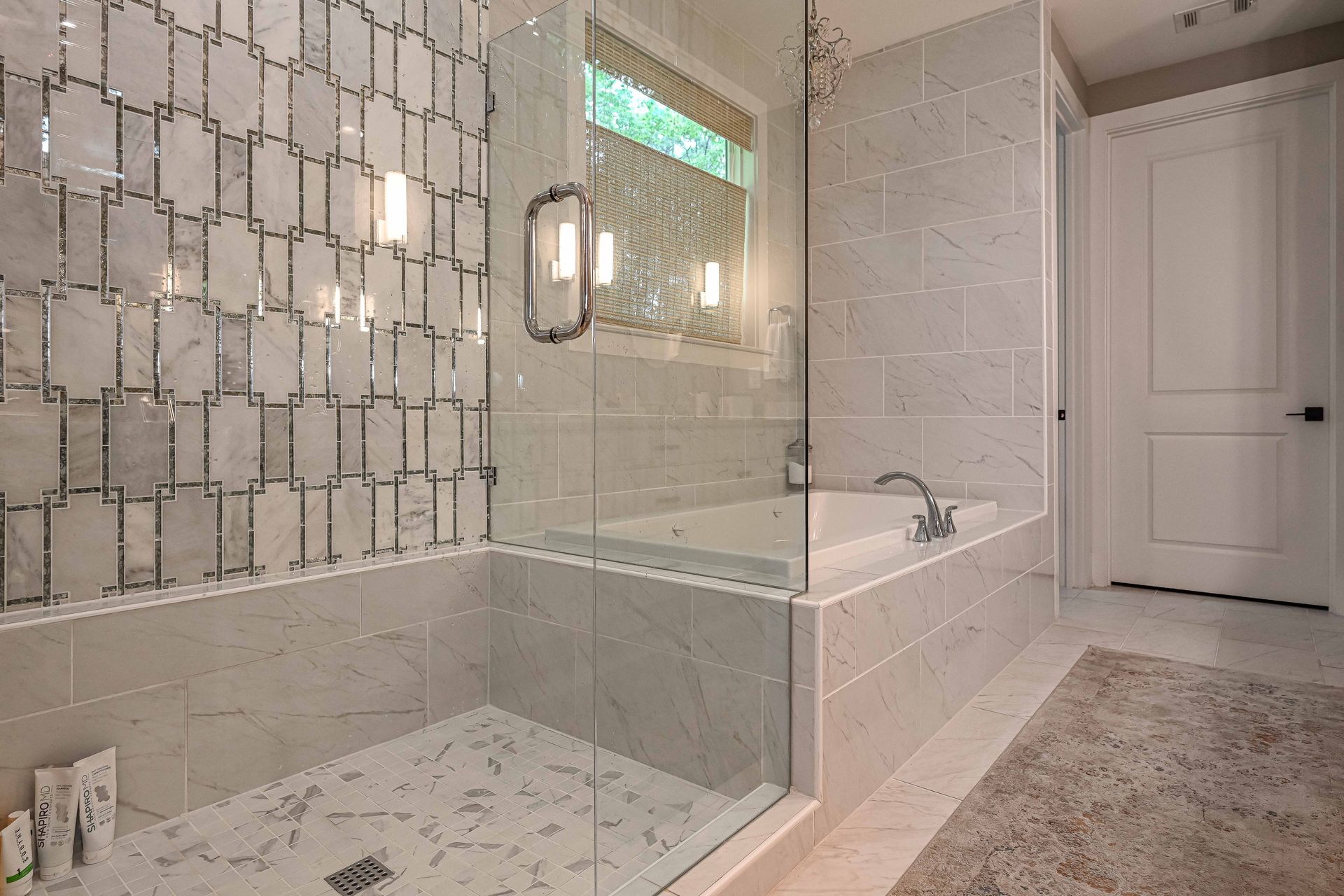 A bathroom with a walk in shower and a bathtub.