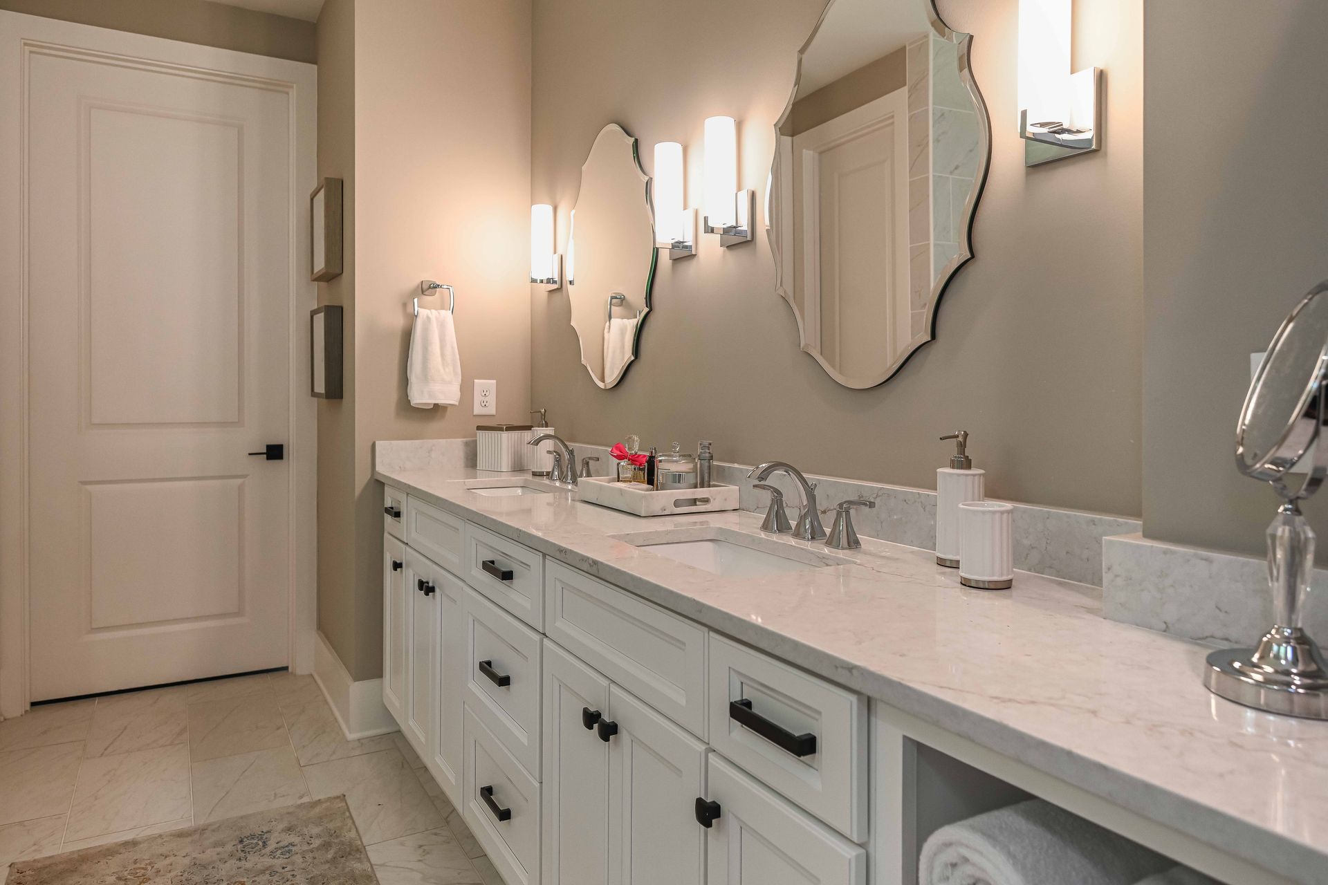 A bathroom with two sinks and two mirrors.