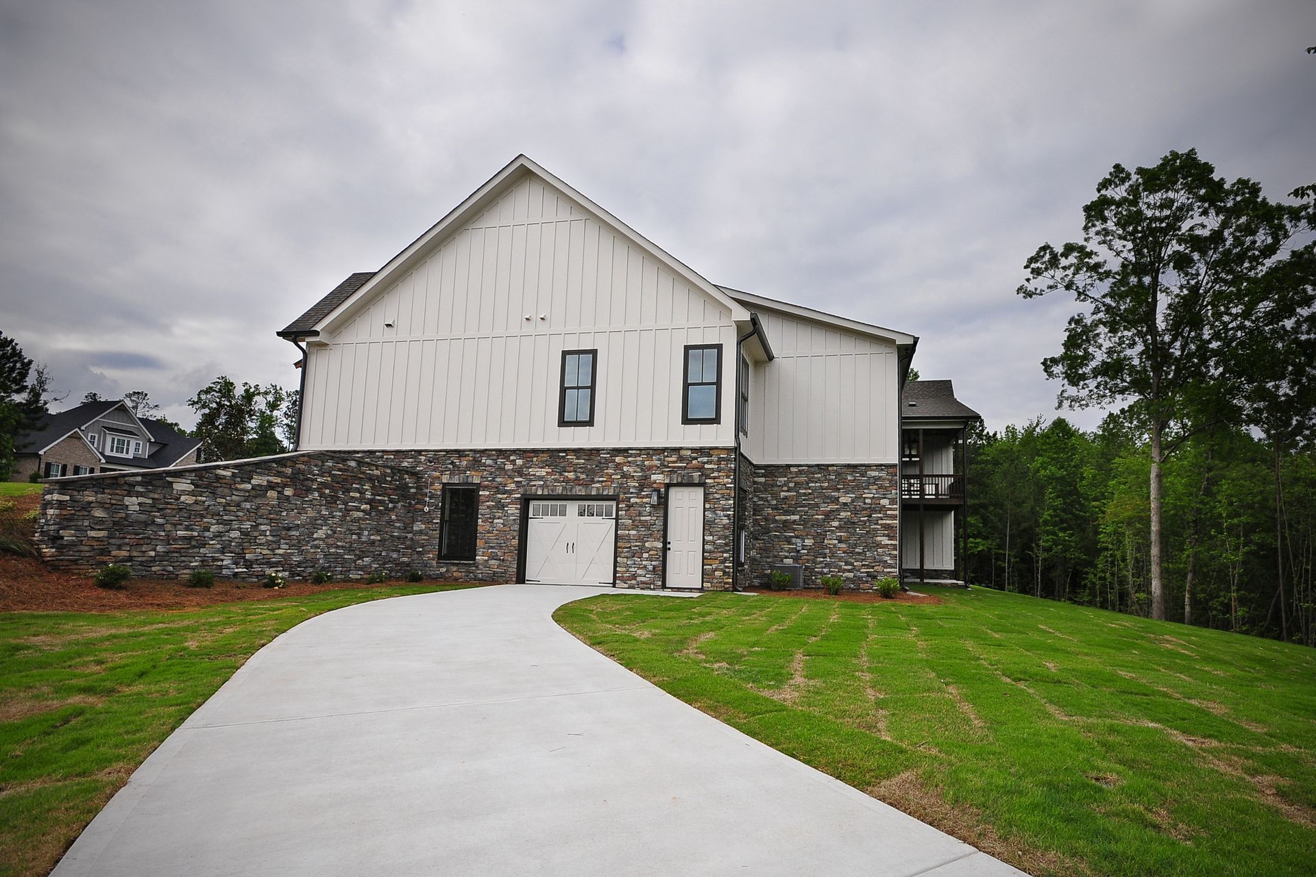 A large house with a concrete driveway leading to it