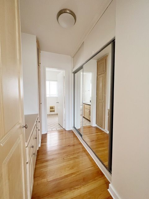 A hallway with a large mirror on the wall