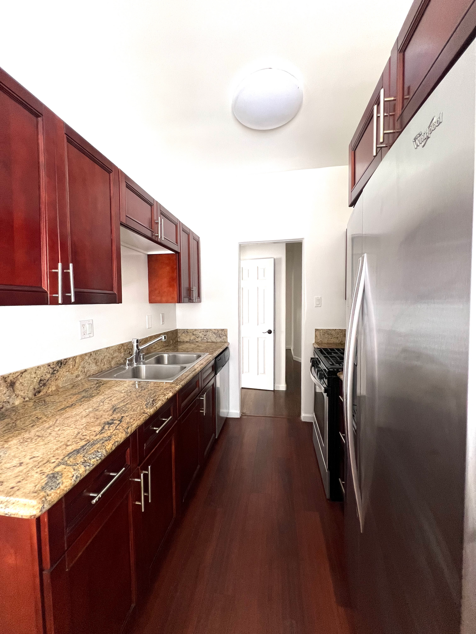 A kitchen with stainless steel appliances and wooden cabinets
