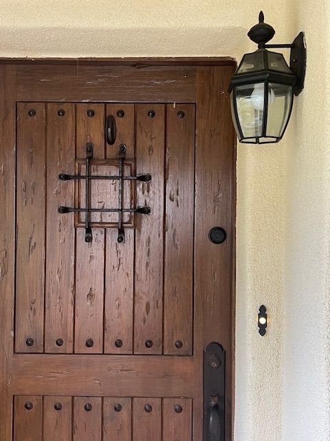 A wooden door with a light on the side of it