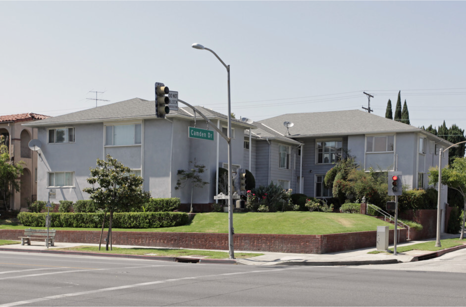 A row of houses are lined up on the corner of a street