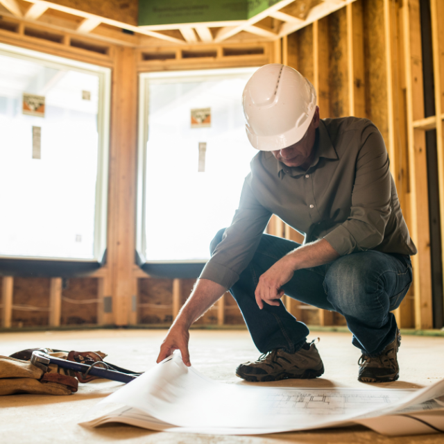 Contractor inspecting a residential foundation