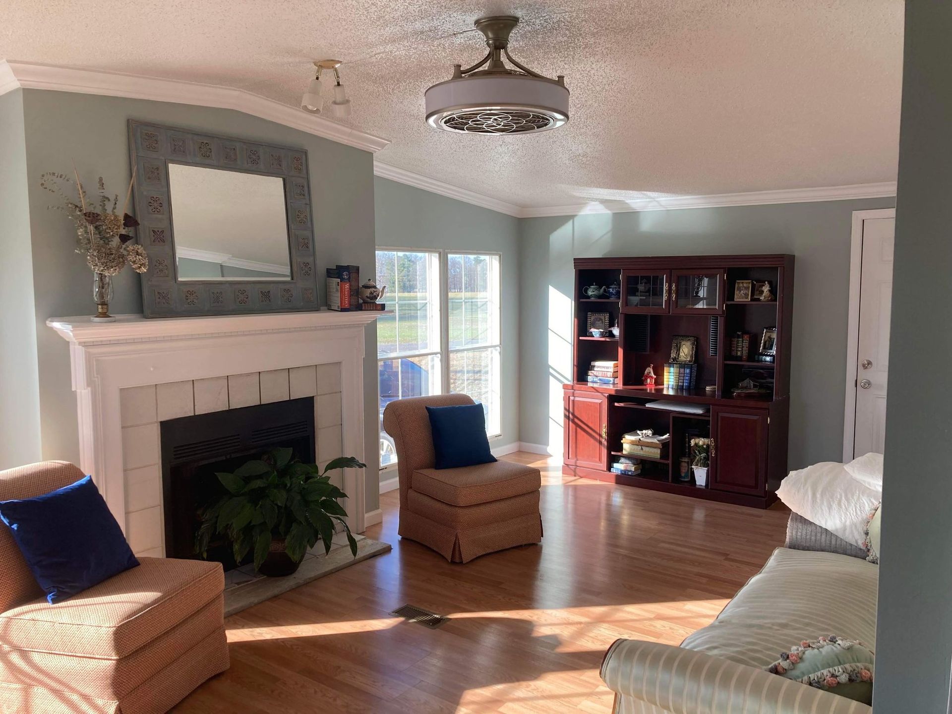 A living room filled with furniture and a fireplace.