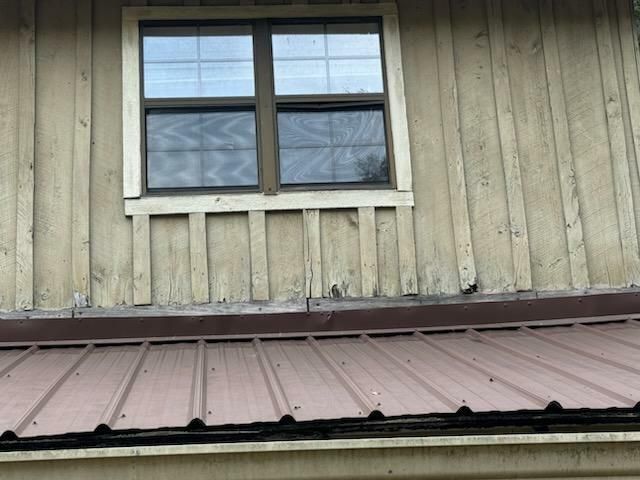 A wooden building with a metal roof and a window