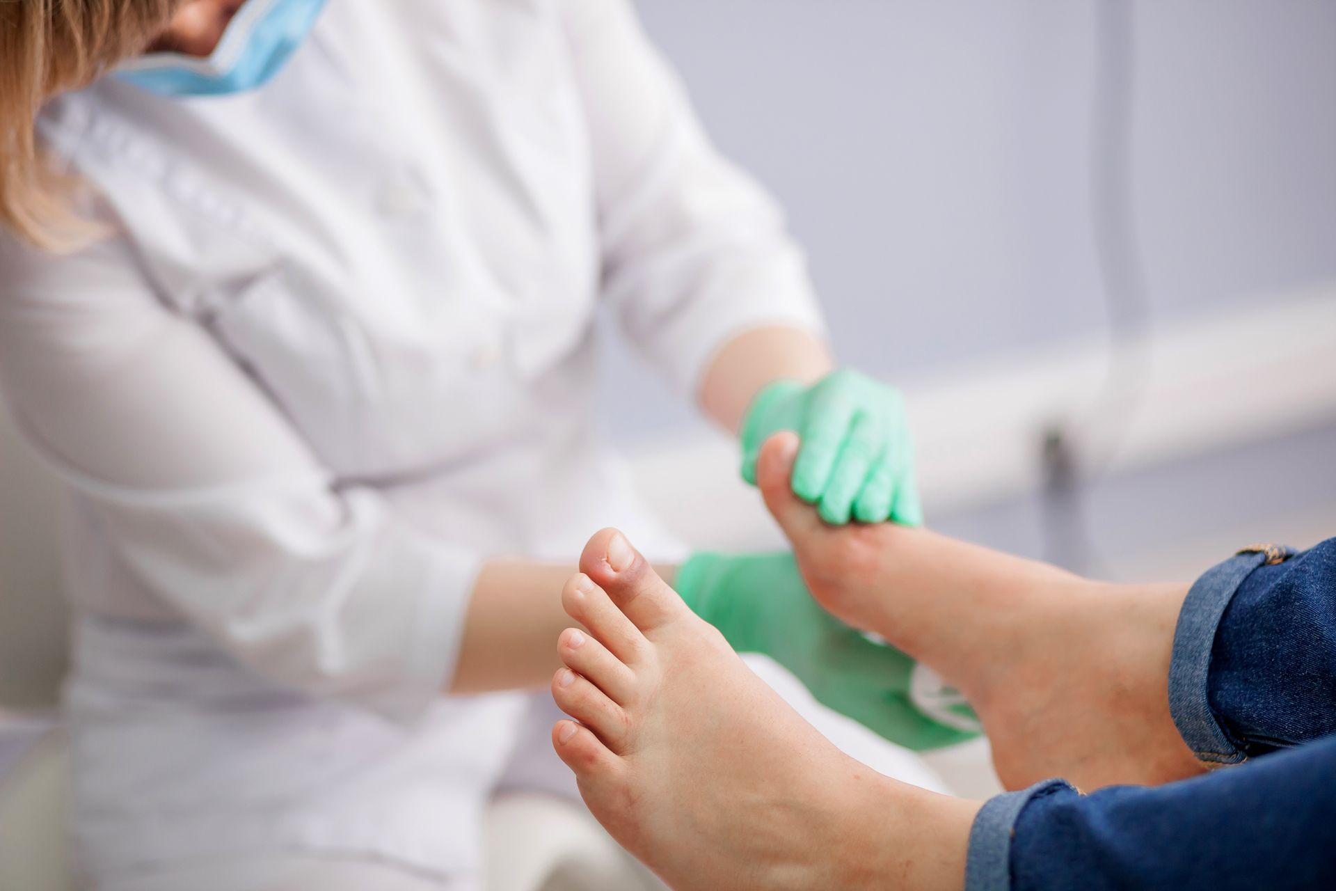 A Doctor is Examining a Patient's Foot in a Hospital