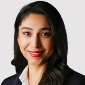 Mona Bakhtiari in a dark blazer with long black hair on a light background