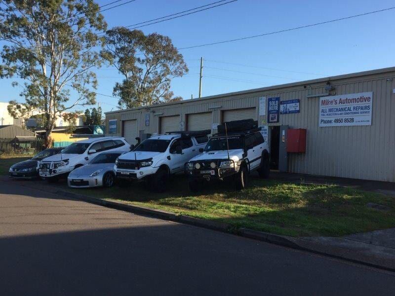 Vehicles Parked Outside a Grey Automotive Shop — Mike's Automotive in Edgeworth, NSW