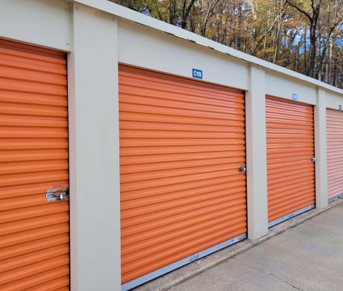 Close view of orange roll-up storage unit doors at StorMark Self Storage on North Fayetteville Street in Asheboro, North Carolina