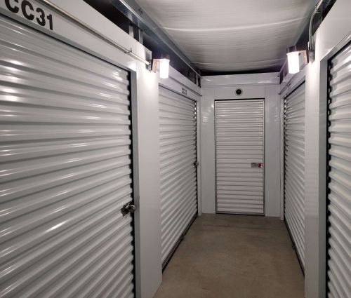 Interior hallway with white roll-up storage unit doors at StorMark Self Storage on US-64 in Asheboro, North Carolina
