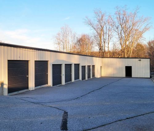 Beige drive-up storage building with black roll-up doors at StorMark Self Storage on Riverside Drive in Danville, Virginia