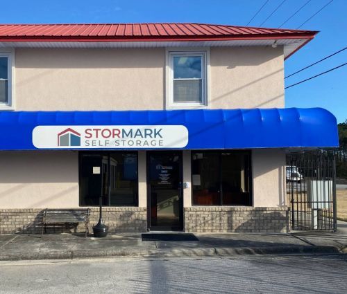 StorMark Self Storage office entrance with a blue awning at 549 Freedom Way in Midway Park, North Carolina