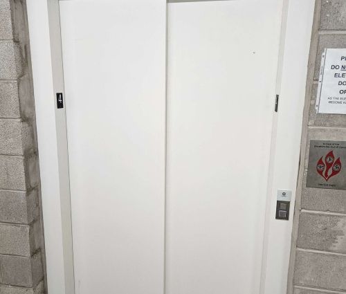 White freight elevator doors inside StorMark Self Storage on West Wisconsin Avenue in Milwaukee, Wisconsin