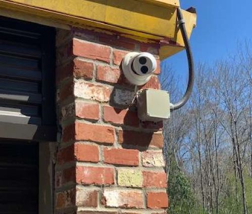 Security camera mounted beside a storage unit door at StorMark Self Storage on Jefferson Street in Newnan, Georgia