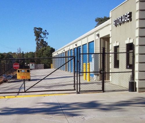 Gated entrance and blue storage unit doors at StorMark Self Storage on South Industrial Drive in Newnan, Georgia
