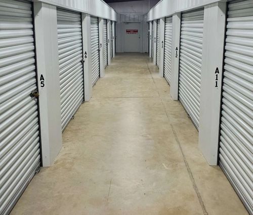 Interior hallway lined with silver roll-up storage unit doors at StorMark Self Storage on South 2nd Avenue in Paragould, Arkansas