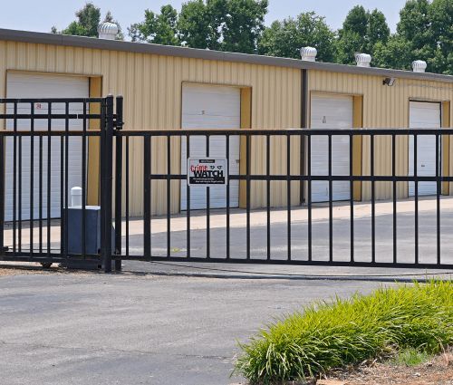 Gated entrance and white storage unit doors at StorMark Self Storage on South 2nd Avenue in Paragould, Arkansas