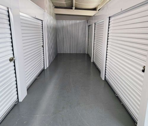 Interior storage area with white roll-up unit doors at StorMark Self Storage on West Kings Highway in Paragould, Arkansas