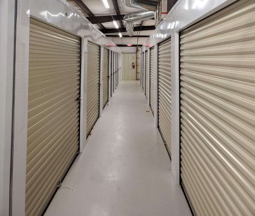 Interior hallway lined with beige roll-up storage unit doors at StorMark Self Storage in Reidsville, North Carolina