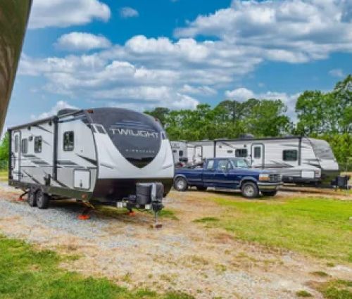 Travel trailers and vehicles parked outdoors.