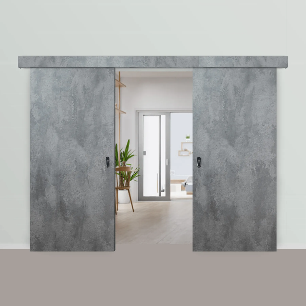Unas puertas correderas grises de estilo granero dan acceso a una luminosa habitación interior.
