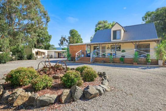 A large house with a lot of rocks in front of it.
