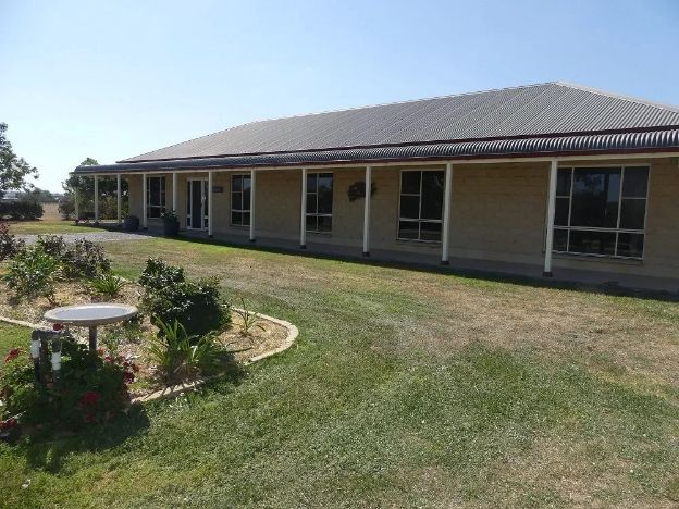 A large house with a porch and a table in front of it