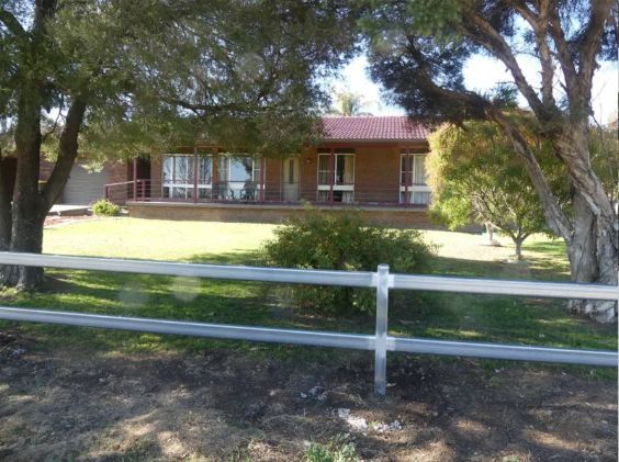 A house with a white fence in front of it